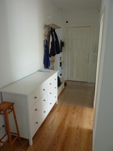 a room with a white dresser and a closet at All you need - Room in Hamburg