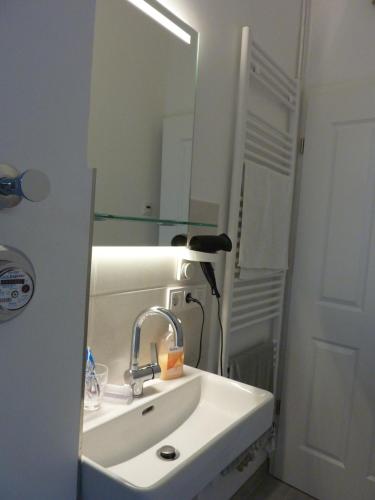 a bathroom with a sink and a mirror at All you need - Room in Hamburg