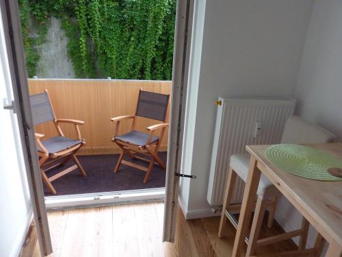 a balcony with chairs and a table in a room at All you need - Room in Hamburg