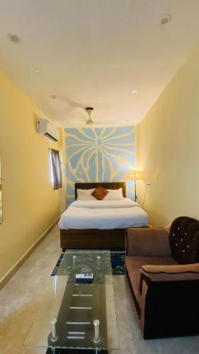 a hotel room with a bed and a couch at The Third Space Varanasi in Rāmnagar