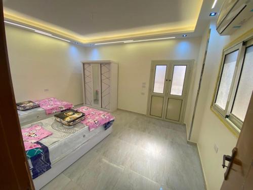 a small room with two beds and a door at Adamora Stay in Marsa Alam City