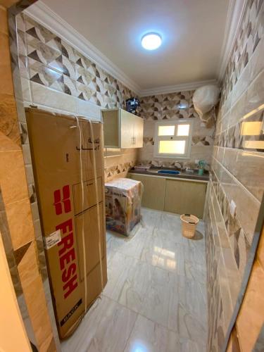 a kitchen with cardboard boxes on the floor at Adamora Stay in Marsa Alam City