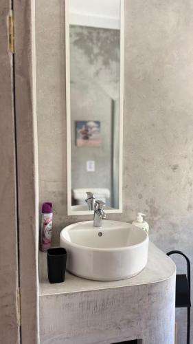 a bathroom with a white sink and a mirror at Habita Avenida 9 Abril in Estremoz