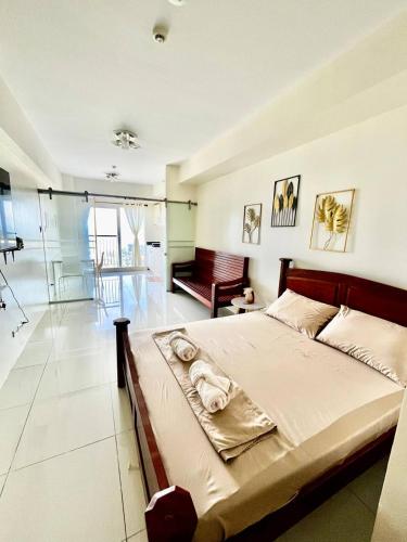 a bedroom with a large bed in a room at SMDC Wind Residences Condo Unit by Bil & J's in Kaybagal