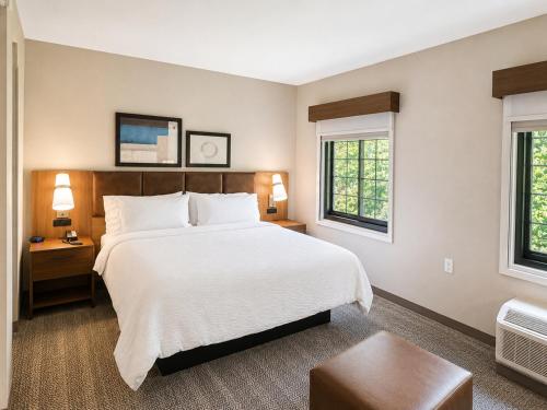 a bedroom with a large bed and two windows at Staybridge Suites Columbia - Baltimore by IHG in Columbia