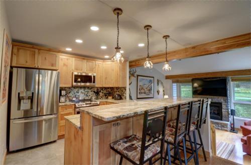 a kitchen with wooden cabinets and stainless steel appliances at Woods 21 Townhome in Copper Mountain