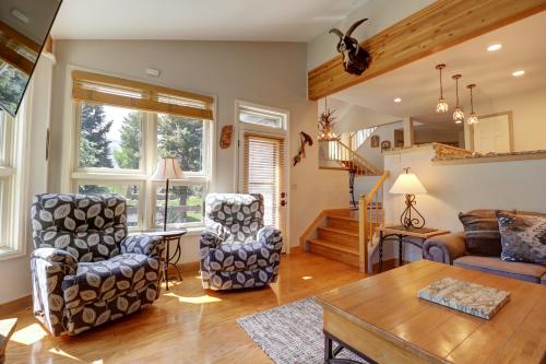 a living room with two chairs and a table at Woods 21 Townhome in Copper Mountain