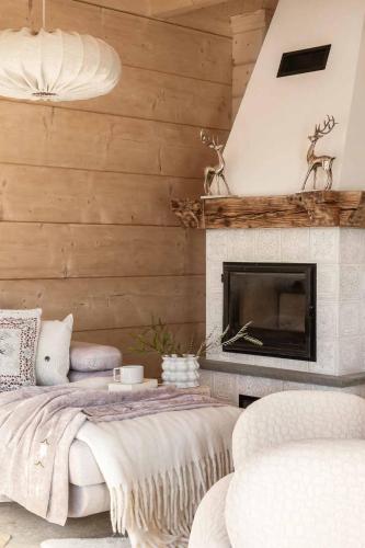 a living room with a bed and a fireplace at Ziębowe Ranczo in Chochołów