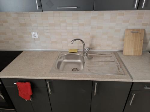 a kitchen counter with a sink in a kitchen at Aphroditi Luxury Vila in Chrysi Ammoudia