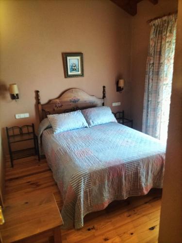 a bedroom with a bed with a wooden floor at Cal Rafalet in Ger