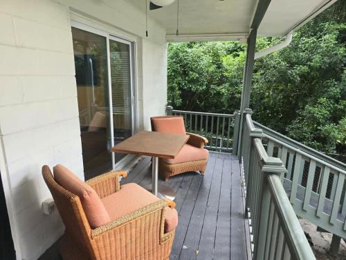 a patio with two chairs and a table on a porch at 2Bed 2Bath Lake Front Jewel in Lake Mary