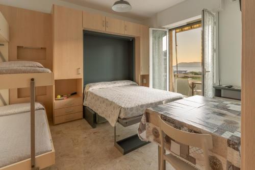 a bedroom with two beds and a table at Residence Riviera in Albenga