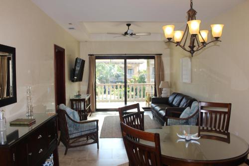 a living room with a table and a couch at The Meridian at Lighthouse Point in West Bay