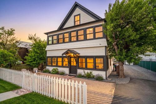 a large white house with a white fence at Downtown Truckee Walkable 6 Bed Pet Friendly in Truckee
