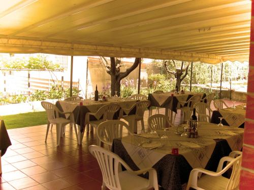 a group of tables with white chairs and tablesearcher at Hotel Azzurra in Sirmione