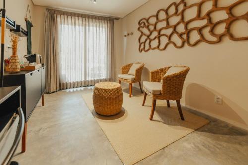 a living room with three chairs and a table at Pousada Moana in Fernando de Noronha
