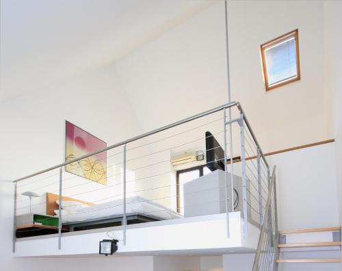 a glass staircase in a white room with at Chelsea Hotel in Cologne