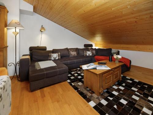 a living room with a couch and a table at Apartment Mon Abri B by Interhome in Les Diablerets