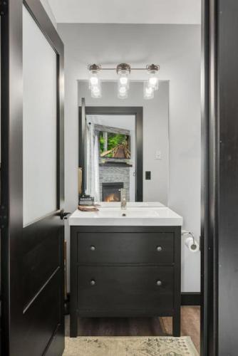 a bathroom with a sink and a mirror at The Serenity Suite with Hot Tub- Main Street Lodge in Berlin in Berlin