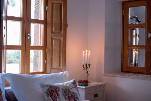 a living room with a couch and candles on a table at Casasantantonio 18th Century Luxury Mansion in Fira