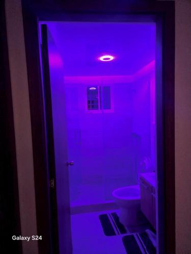 a room with a purple light in a bathroom at Peace Place in Santiago de los Caballeros
