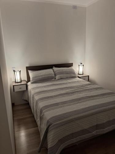 a bedroom with a large bed with two night stands at La Morada en Funes in Funes