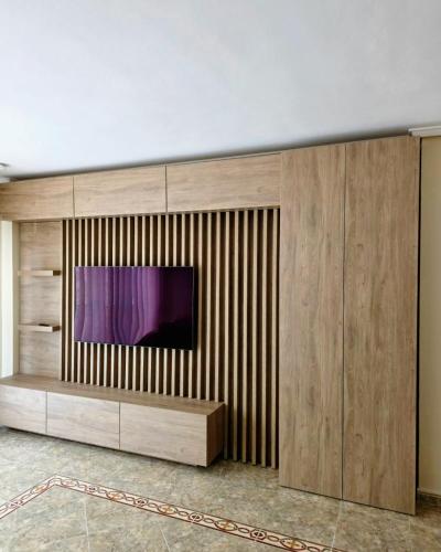 a large entertainment center with a tv on a wall at Entire Apartment near Valencia - 2 Bedrooms & 2 Bathrooms in Paterna