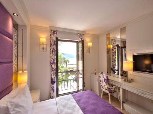 Ένα ή περισσότερα κρεβάτια σε δωμάτιο στο Baga Hotel