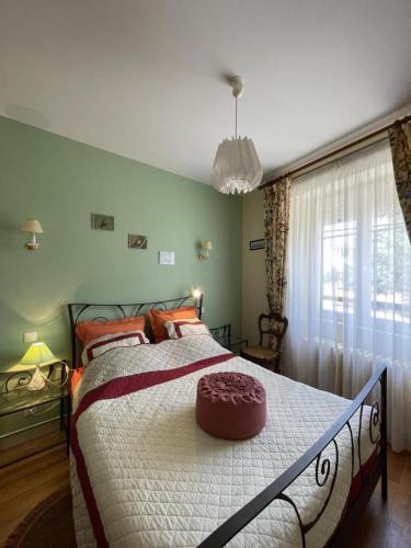 a bedroom with a large bed with a cake on it at Gîte de la lionnaire in Orches