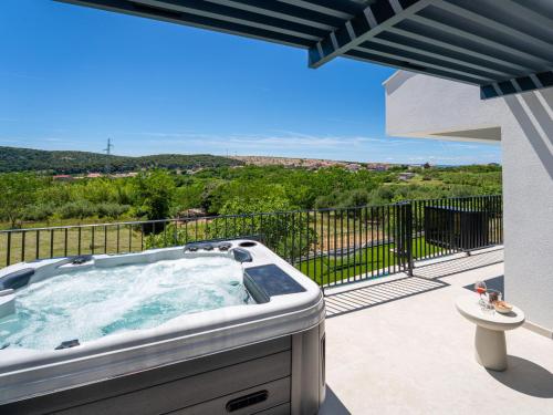 a hot tub on the balcony of a house at Villa Loparia by Interhome in Lopar