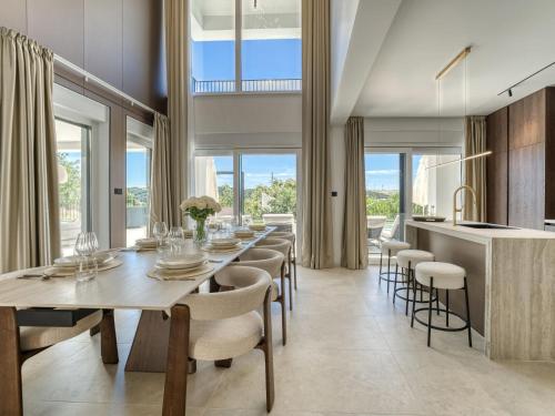 a dining room with a long table and chairs at Villa Loparia by Interhome in Lopar