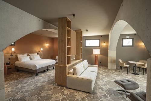 a hotel room with a bed and a couch at La Chapelle in Annecy
