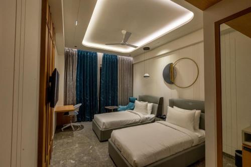 a hotel room with two beds and a mirror at Hotel Vintana in Nananpur