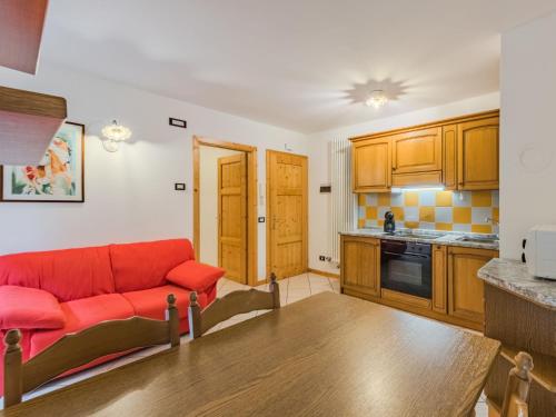 a living room with a red couch in a kitchen at Apartment Betulla by Interhome in Rabbi