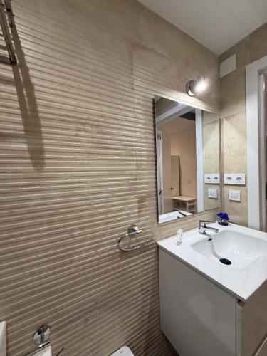 a bathroom with a sink and a mirror at Casa Azul in Villajoyosa