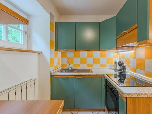 a kitchen with green cabinets and a sink at Apartment Abete by Interhome in Rabbi