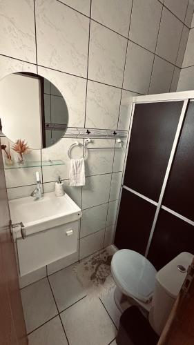 a bathroom with a toilet and a sink and a mirror at Quarto privativo com penteadeira LED - n 326A in Petrolina