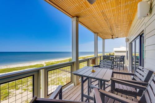 a balcony with tables and chairs and the beach at Windward Crest by Pristine Properties Vacation Rentals in Port Saint Joe
