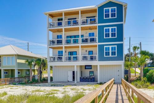 a building on the beach with a boardwalk at Windward Crest by Pristine Properties Vacation Rentals in Port Saint Joe