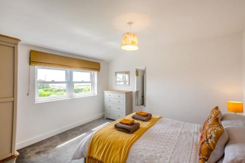 a white bedroom with a bed and a window at 2 Bed in Llanfair oc-a30451 in Llanfair