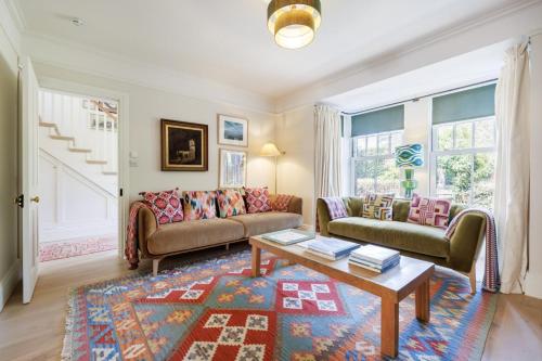 a living room with two couches and a coffee table at Sandown, Spacious and Stylish in Southwold in Southwold