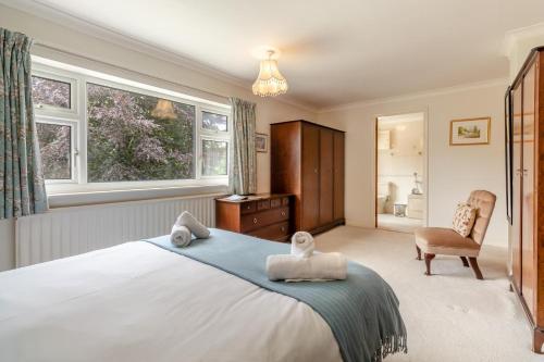 a bedroom with a large bed with towels on it at 4 Bed in Halesworth oc-willho in Halesworth