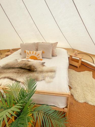 a bedroom with a bed in a tent at LaplandLiv Glampingtent with private sauna at the lake! in Mellanström