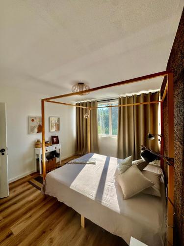 a bedroom with a large bed and a window at Os Marias in Tomar