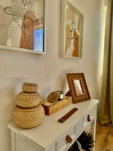a white table with some baskets on top of it at Os Marias in Tomar