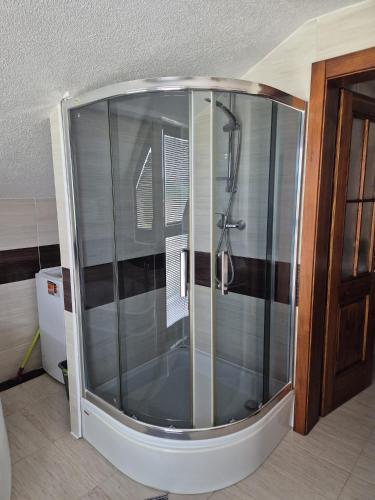 a shower with a glass enclosure in a bathroom at Apartmán Ružiná in Ružiná