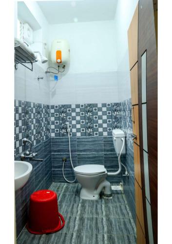 a bathroom with a toilet and a sink at Anbu Grand Inn in Chidambaram