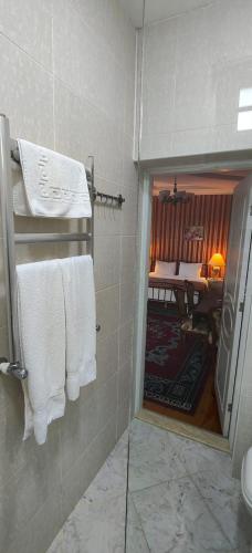 a bathroom with white towels hanging on a wall at Retro Silent Boutique Hotel in Baku