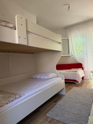 a bedroom with a bunk bed and a staircase at The Lakehouse in Krnjice