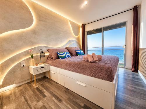 a bedroom with a bed with a view of the ocean at Ocean Soul Apartment in Santa Cruz de Tenerife